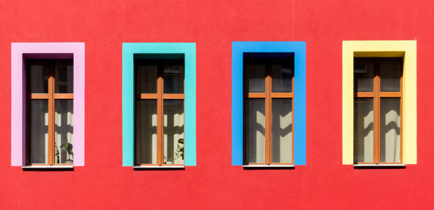 Germany, Berlin, Kreuzberg , July 07, 2024 -Red house facade with colorful windows