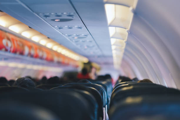 istock Wide view full passenger in seat daytime flight economy class airplane long flight from thailand to japan 2164199528