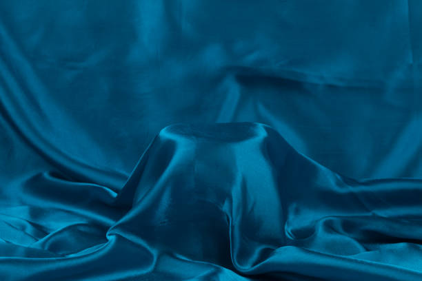 istock A general term for shiny fabric woven with silk thread. Light, elegant in color, and soft to the touch. Background 2164203614