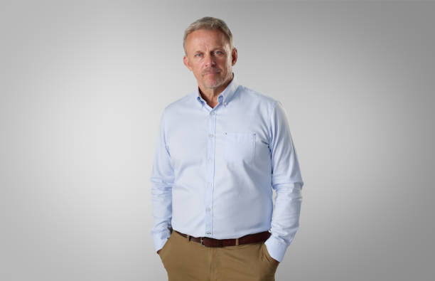 istock A Middle-Aged Man Wearing a Light Blue Long-Sleeve Shirt and Khaki Pants 2164209018
