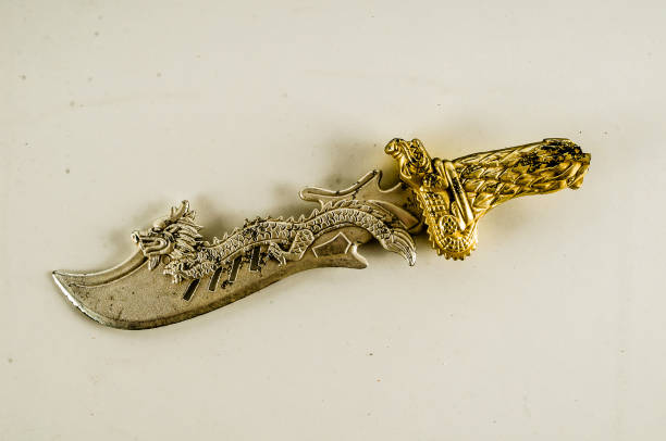 istock A gold and silver sword with a dragon on it 2164216026