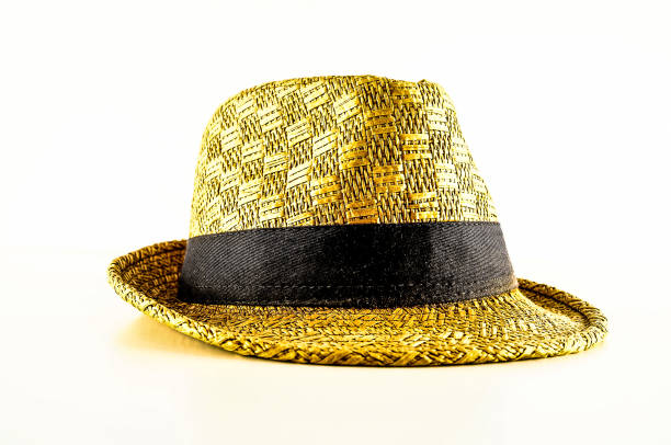 istock A yellow hat with a black band sits on a white background 2164216037