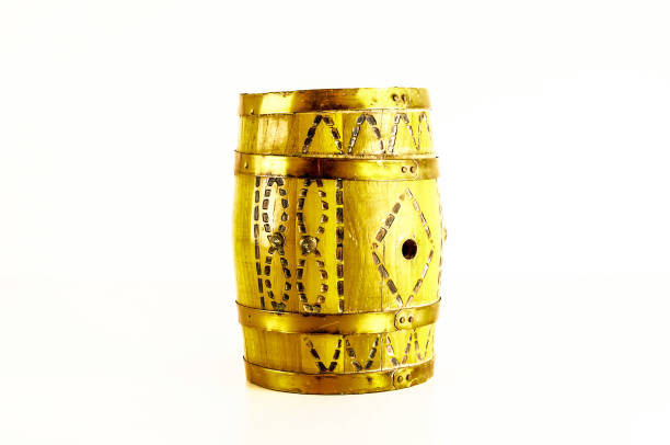 A yellow barrel with a gold handle sits on a white background. The barrel is decorated with a pattern of squares and triangles