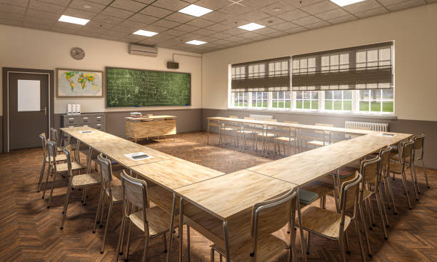 istock Empty classroom with wooden desks and chalkboard waiting for students to arrive 2164217965