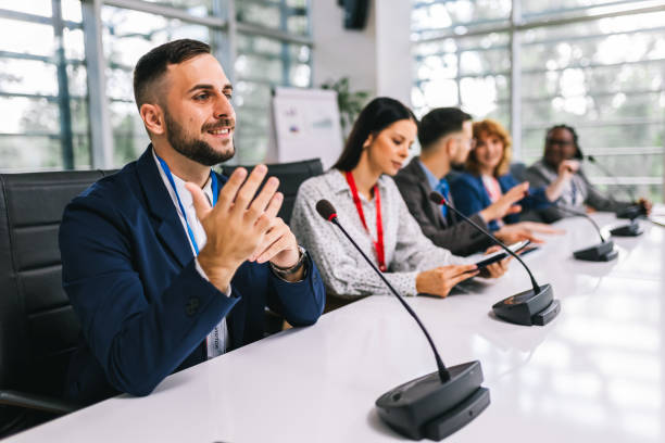 istock Man CEO talking on the microphone on meeting with his colleagues about business plan, future collaboration. 2164221075