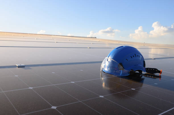 istock Engineer's helmet and drone equipment placed on solar panels on solar panel clean energy concept. 2164223031