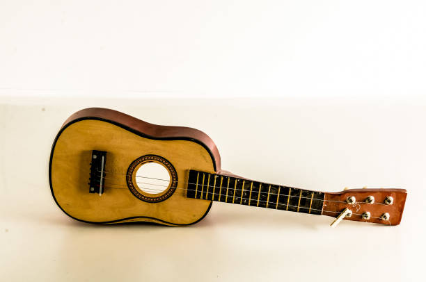 istock A small guitar is sitting on a white table 2164224077