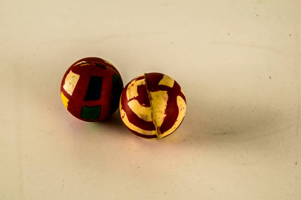 istock Two balls with a red and yellow design on them 2164224104