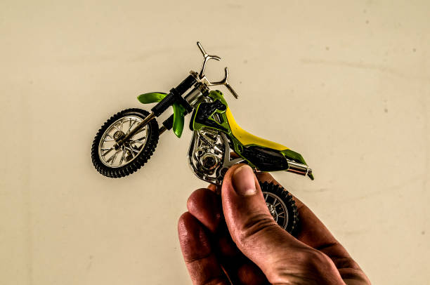 istock A hand holding a toy motorcycle 2164224114