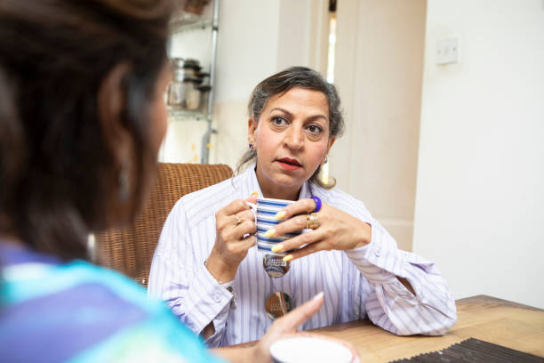 istock Mature women having a coffee break together in a kitchen 2164229170