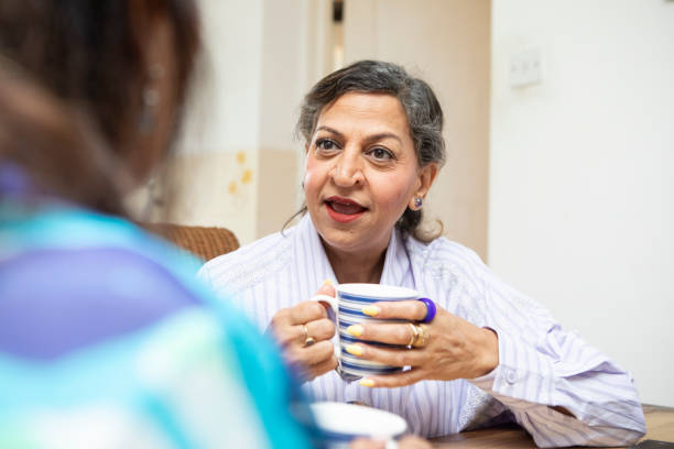istock Mature women having a coffee break together in a kitchen 2164229177