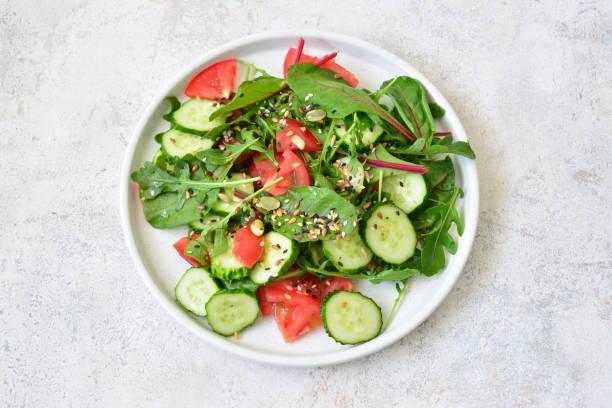 istock fresh vegetables with seeds and arugula on the plate top view 2164229821