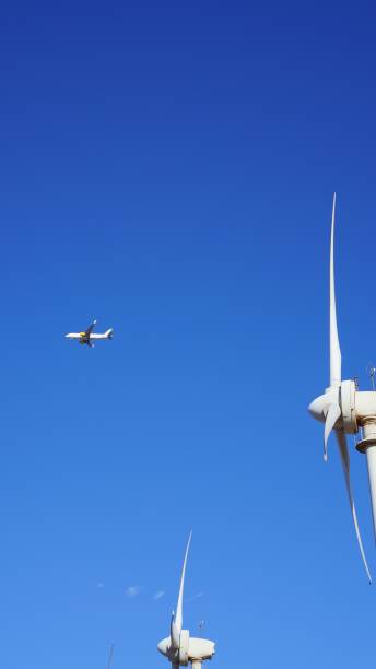 istock Wind Turbines and Airplane in Flight 2164232010