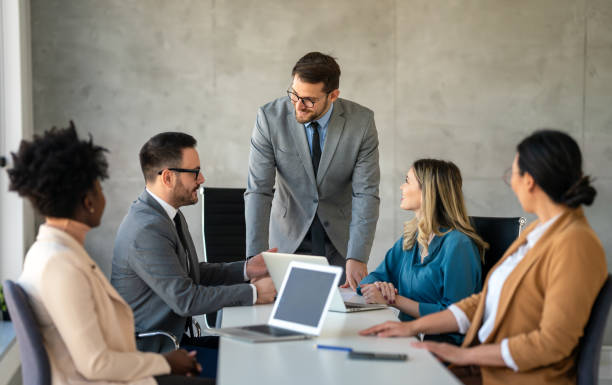 istock Successful multiethnic business people presenting analytical report while working together in office 2164233726