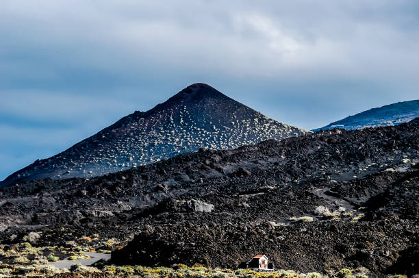istock A mountain with a small house on top of it 2164234154