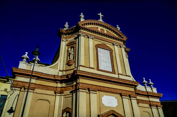 A large, ornate building with a clock on the front. The building appears to be a church, and the clock is prominently displayed on the front. Scene is one of grandeur and importance