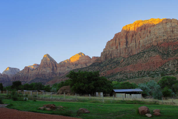 istock Sunrise on Old Farm Structure and Desert Mountain Range 2164241763