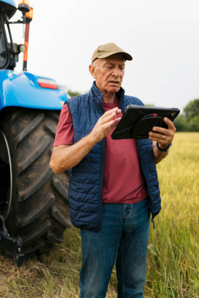 istock Senior male farmer using digital tablet on field 2164242484
