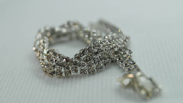 istock A bracelet with shiny small stones on a white background close-up 2164242497