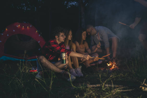 istock friends roasting marshmallows over the fire in a grill 2164244298