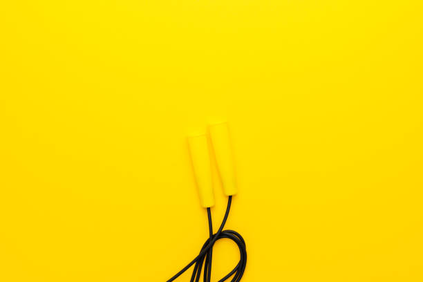 istock top view of skipping rope on yellow background with copy space 2164244416
