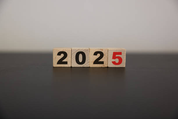 istock Wooden cube block with 2025 text on table background. Resolution, plan, review, goal, start and New Year holiday concepts 2164245756