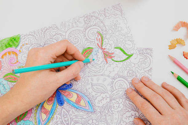 istock Hands Coloring Intricate Mandala Design By Colored Pencils 2164249200