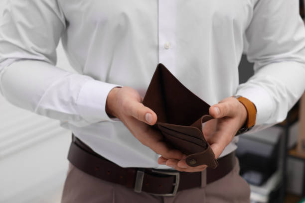 istock Man with empty wallet in office, closeup 2164250040