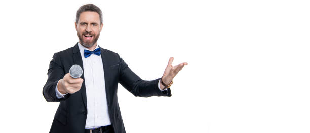 istock man speaker wear tuxedo in studio with copy space. speaker man speaking in microphone. 2164253487