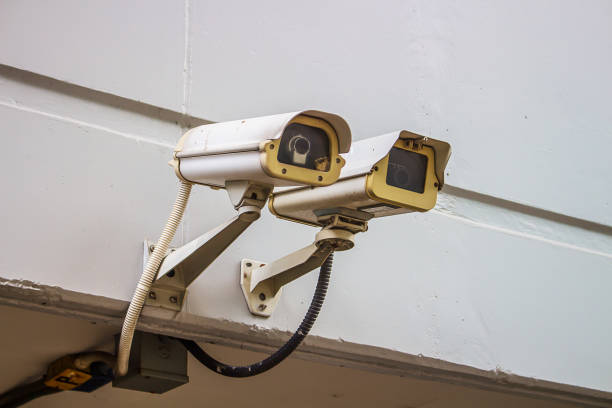 istock two outdoor video surveillance cameras on a concrete wall, security system. 2164254309