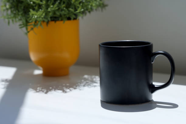Coffee cup on table photo taken in natural sunlight