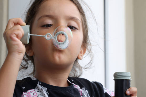 Little Girl Blowing Bubbles