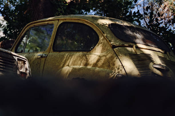 istock An old yellow car with a rusty body. 2164257321