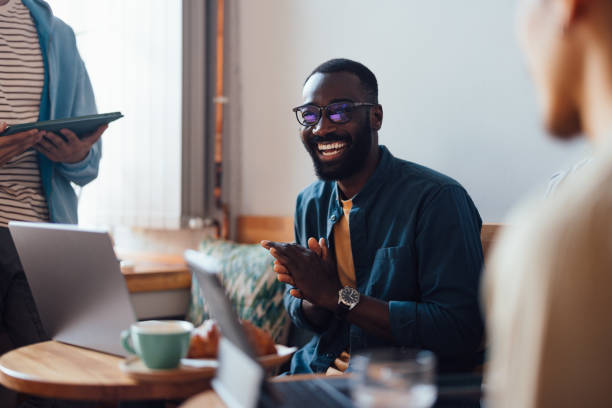 istock Friends Working and Socializing in a Cozy Cafe Environment 2164260700