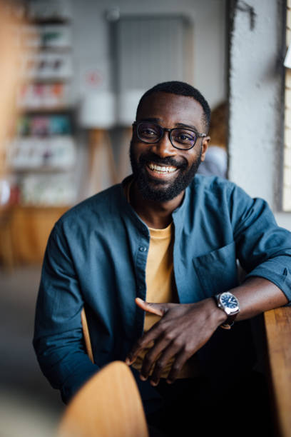 Smiling Man Sitting in a Cozy Cafe