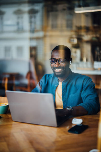 istock Man Working on Laptop in Cozy Cafe with Coffee 2164260766