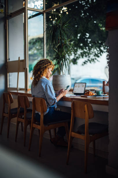 istock Woman Working On Laptop In A Cozy Cafe 2164260782