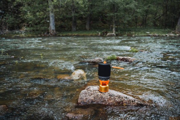 istock Stove placed on rock in river surrounded by natural landscape 2164260965