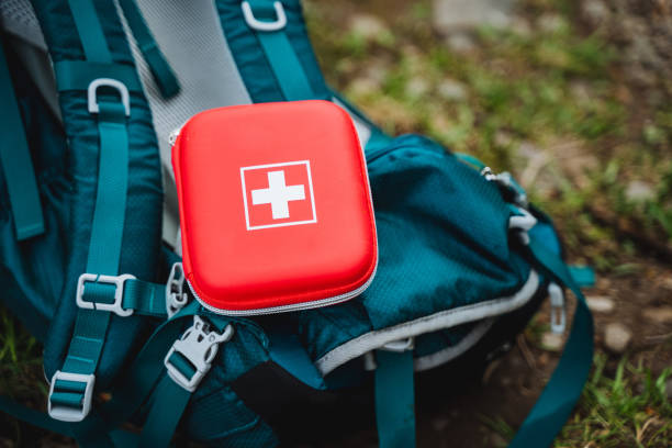 istock A first aid kit sits atop a blue backpack by a motor vehicle 2164260997