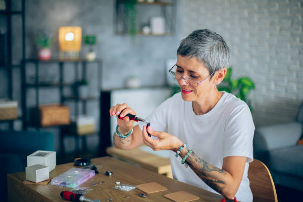 istock Senior woman making jewelry in a home workshop 2164262570