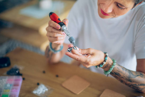 istock Senior woman making jewelry in a home workshop 2164262749