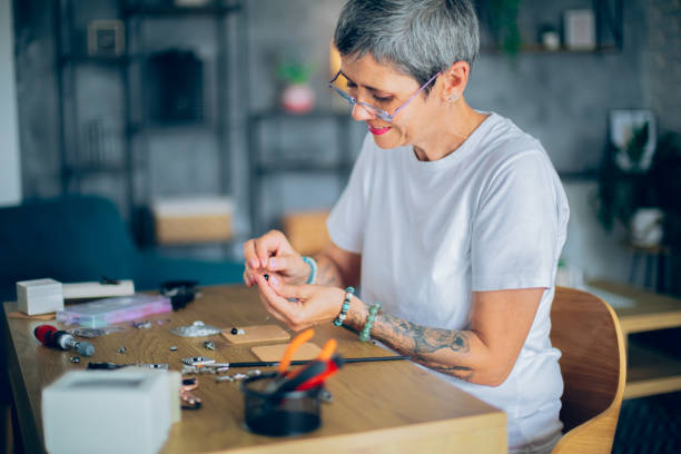 istock Senior woman making jewelry in a home workshop 2164262762