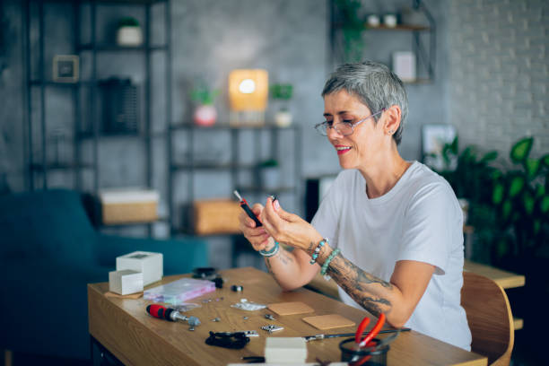 istock Senior woman making jewelry in a home workshop 2164262773