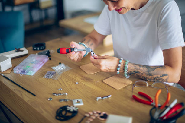 istock Senior woman making jewelry in a home workshop 2164262828