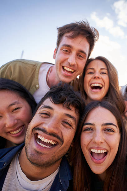 istock Portrait group diverse young happy people looking excited at camera having fun together outdoor. 2164263488