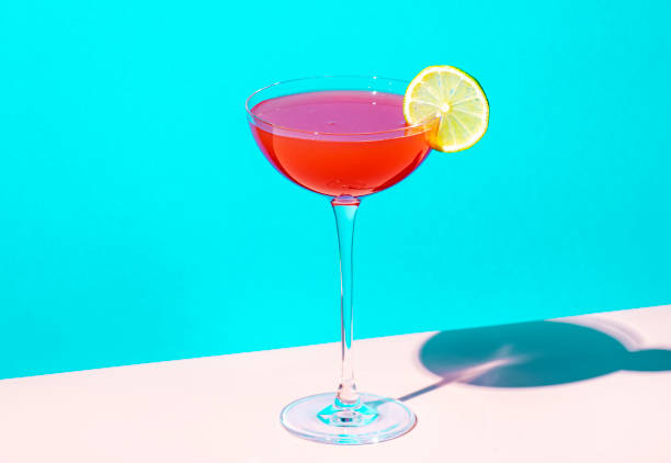 istock Siesta cocktail drink with tequila, grapefruit and lime juice, syrup and red bitter, liqueur. Blue background, hard light and shadows 2164264269