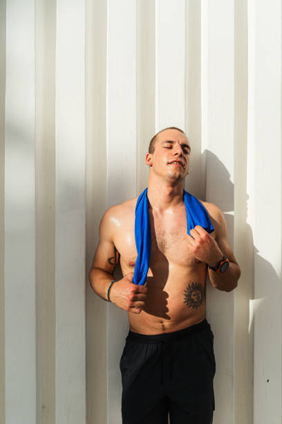 Young man resting after taking a cross training outdoors