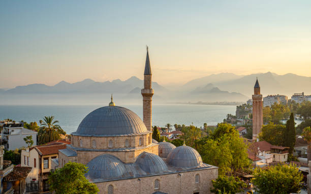 Old Town Antalya, Tekeli Mehmet Pasa mosque and Yivli (Fluted) Minaret at sunset, Antalya, Turkey stock photo