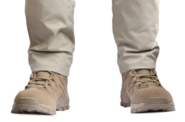 istock Beige tactical desert boots and durable ripstop pants, khaki tan suede leather army combat footwear and casual men's trousers, brand new apparel detail, large detailed isolated horizontal SOF clothing closeup, low angle feet view, white background 2164266192