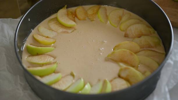 istock Unbaked apple pie with fresh sliced apples in a round baking pan 2164266197